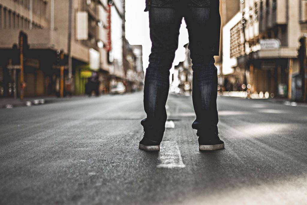 man stands in street