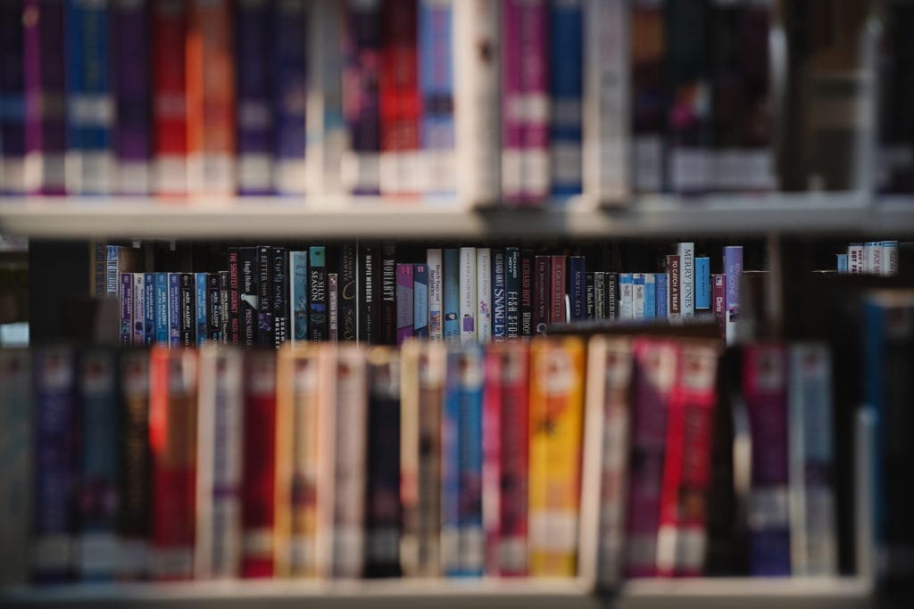 stacks of colorful books on shelves