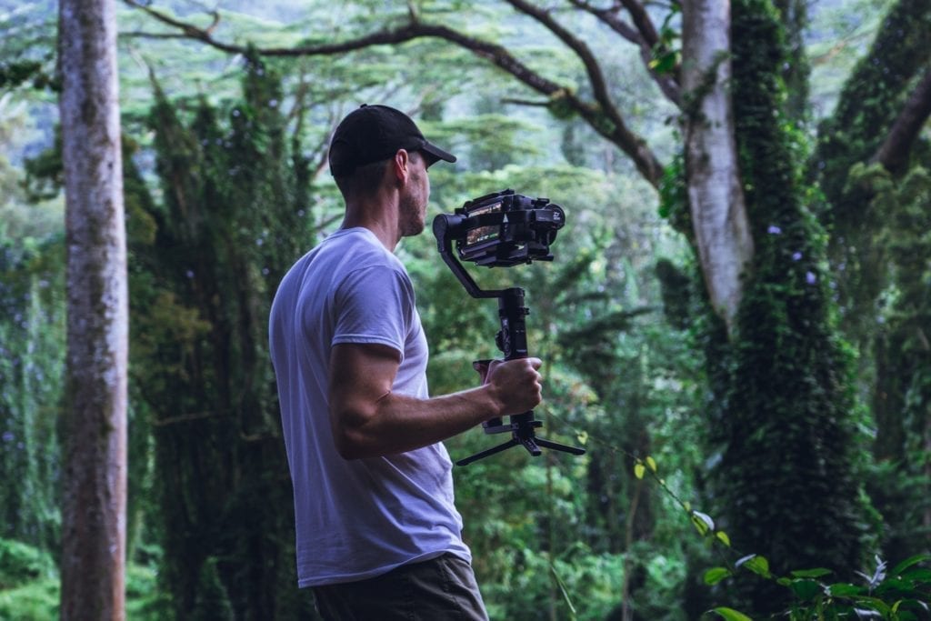 indie filmmaker in the woods filming a scene the film fund