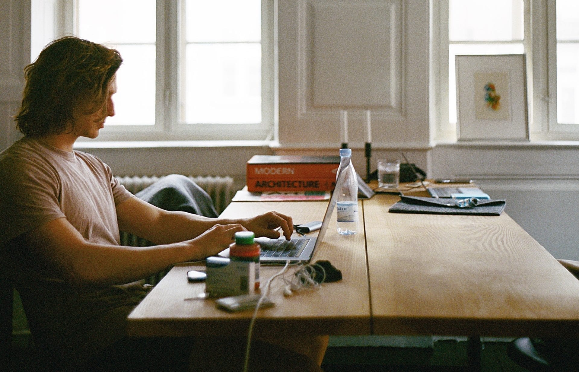 man sitting at desk with laptop