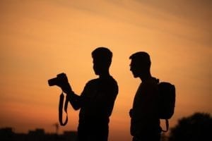 silhouette of two filmmakers with a camera