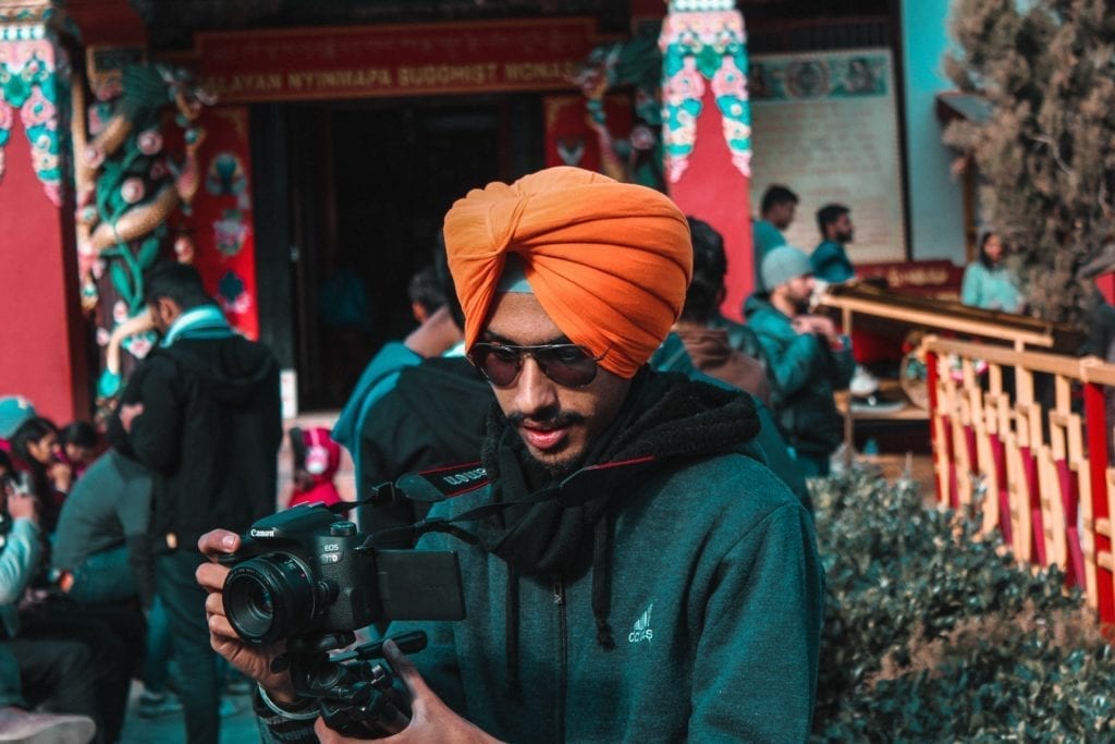filmmaker wearing turban holding camera