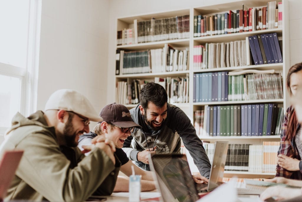 creatives looking at laptop smiling