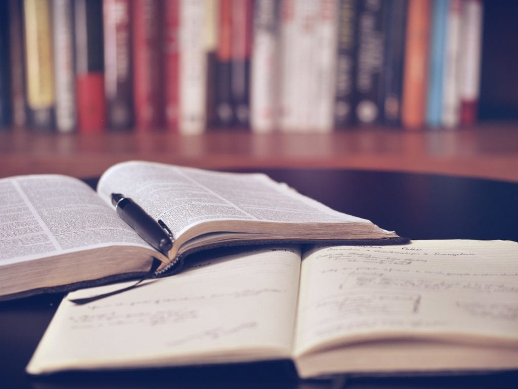 screenwriting books stacked with pen in library