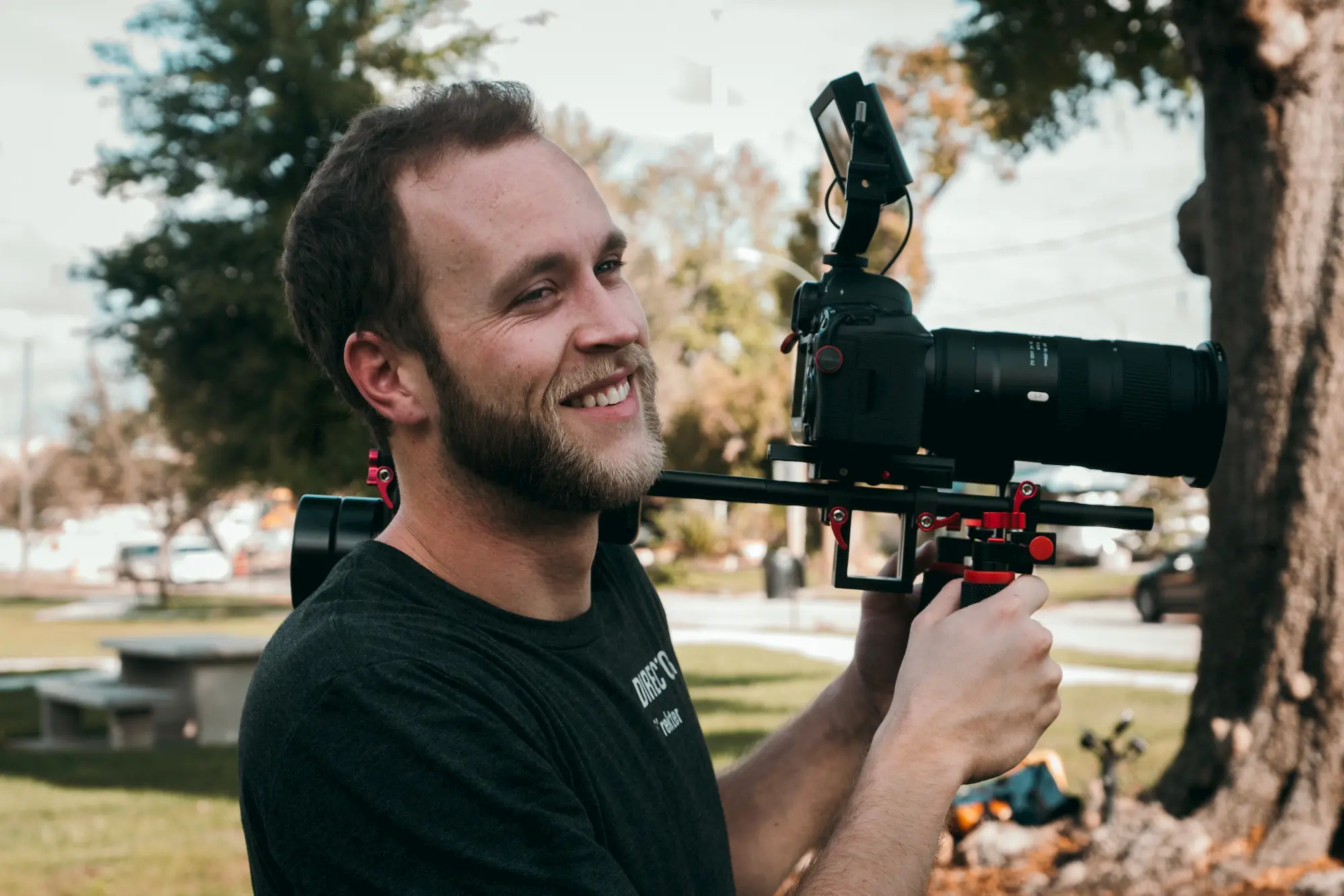 filmmaker in park with shoulder mount