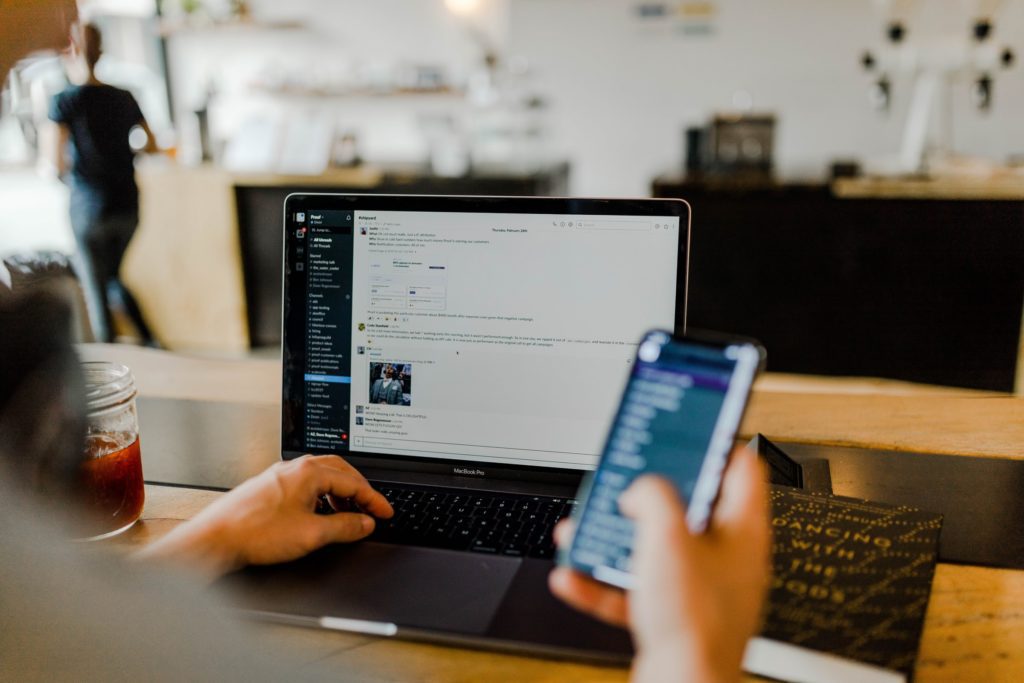 chatting in slack on iphone and laptop