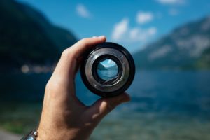 looking through lens at lake and mountains