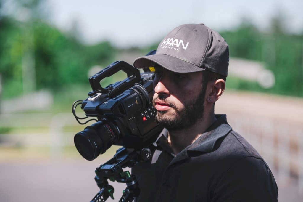 independent filmmaker cinematographer on set with camera