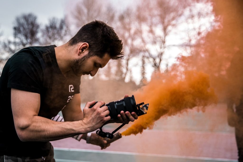 independent filmmaker with camera and smoke on set