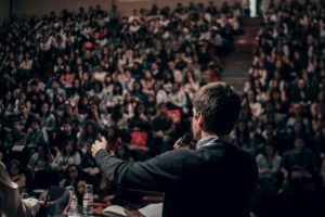 man lecturing before documentary film screening college