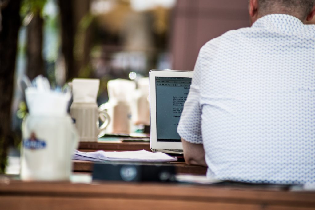 Man writing screenplay in coffeeshop