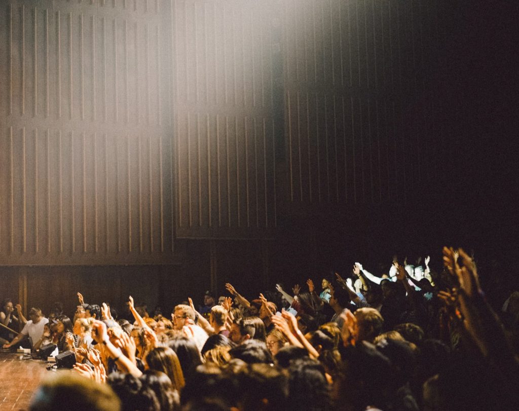 students raising hands listening to independent filmmaker