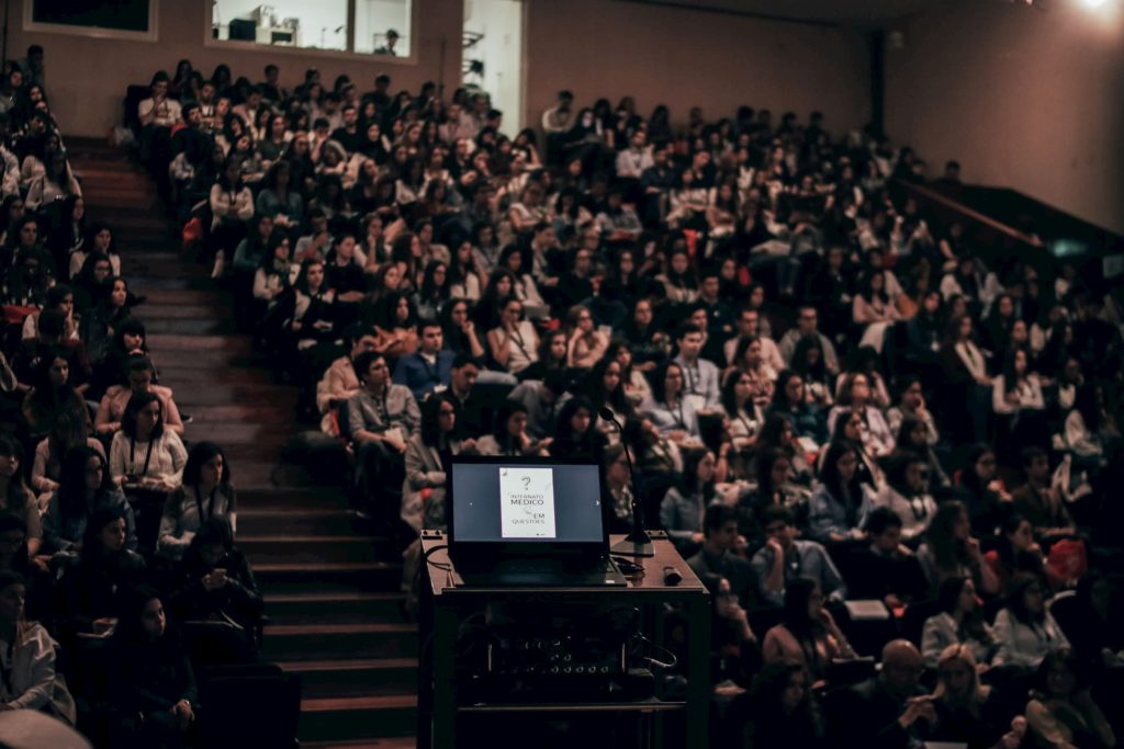 students watching independent documentary film in college lecture hall