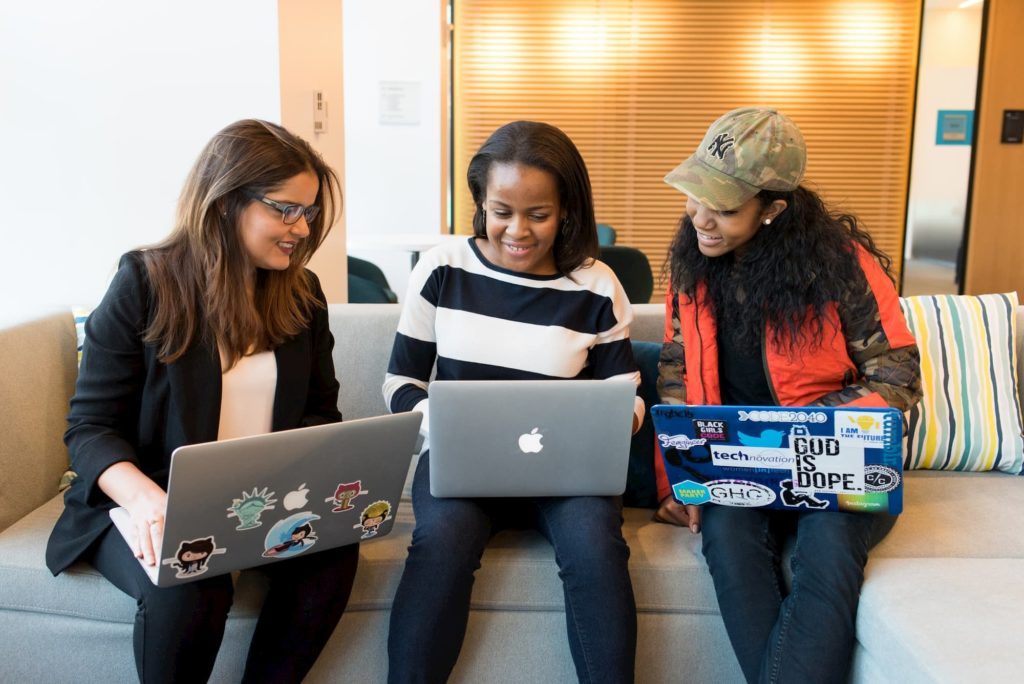 female filmmakers networking on laptops at meeting