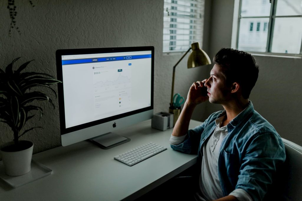 man studying online course on computer