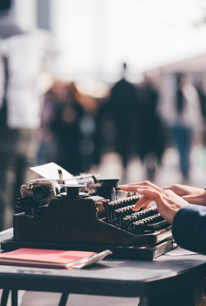 screenwriter typing screenplay script on typewriter