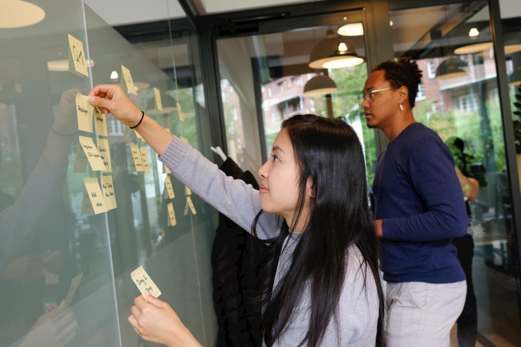 A girl creating an outline with postit notes