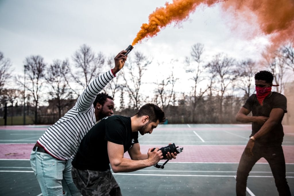 three men behind the scenes filming the film fund