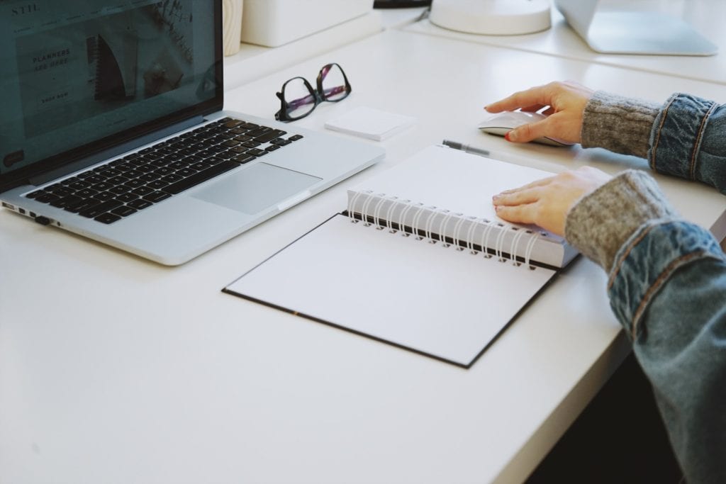 girl using a planner and laptop to get organized film fund