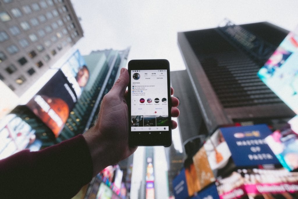 person holding phone up at the sky the film fund