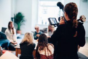 Women filming a group of people the film fund