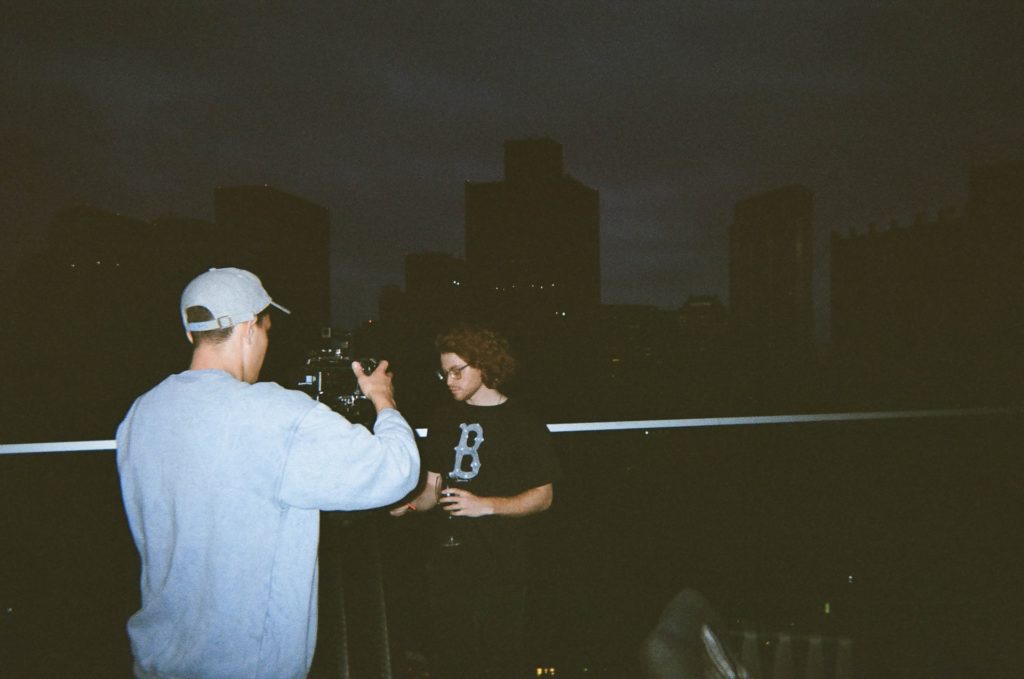 two people filming at night in the city the film fund