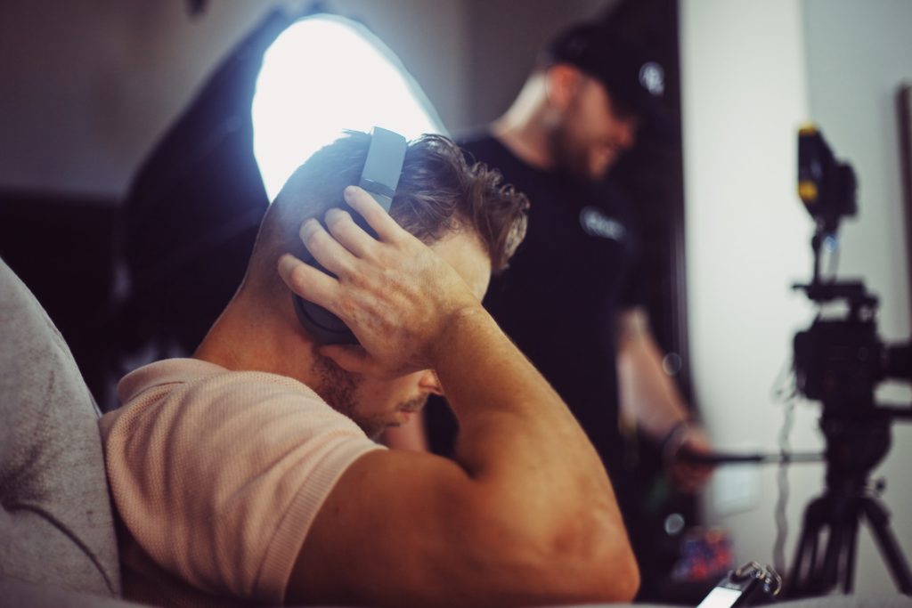 man with headphones examining monitor the film fund