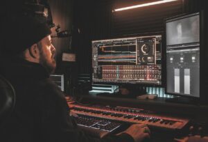 Audio engineer utilizing an audio mixing program at his workstation.