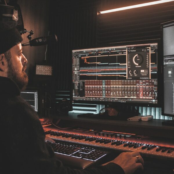 Audio engineer utilizing an audio mixing program at his workstation.