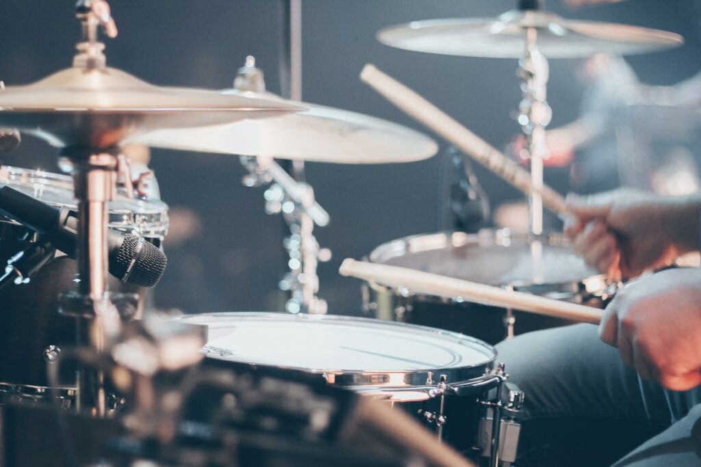 A person playing the drumkit.